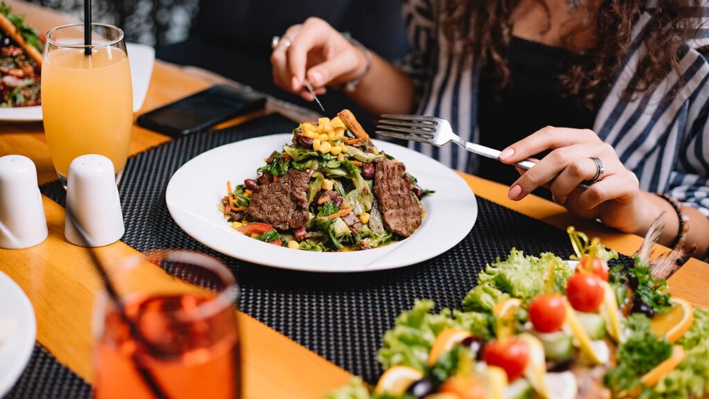 Family sharing grilled dishes during lunch outing
